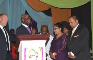 Photo: Milton Grannum (center), Jim Lyon (left), and CHOG Guyana leaders pray for Guyana's prime minister and his wife (right). Guyana_Centennial_PrimeMinister_prayer_adj_FORWEB