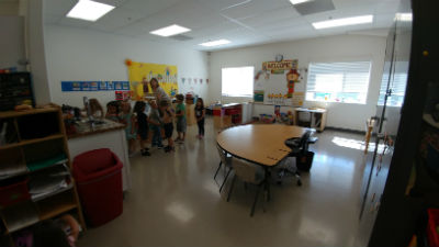 Photo: Children and teacher in one of the new classrooms.