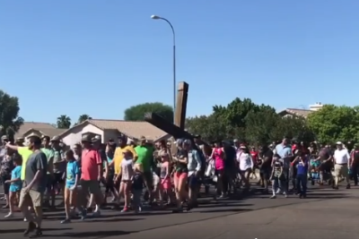 Photo: Carrying the cross from the old property to the new.
