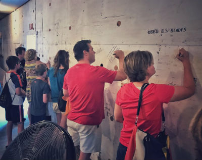 Photo: Congregation writing Scriptures and prayers on the walls of the new building during renovation.