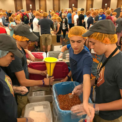 Photo: Students from The Church at Bradenton (FL) pack meals on Impact Day.