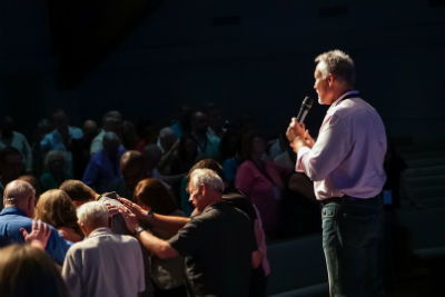 Photo: Ken Love leads prayer for the Sarasota church plant.