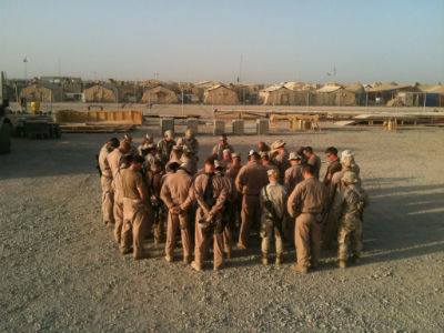 Photo: Chaplain Miller prays prior to a mission in Afghanistan.