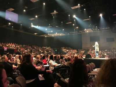 Photo: Lori Salierno-Maldonado addressing a packed house.