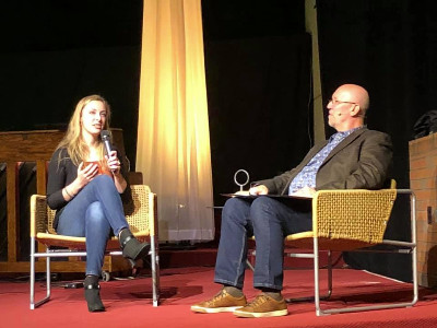 Photo: Pastor Mark Martin interviews artist Julia Armstrong.